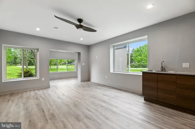 a bathroom with a granite countertop sink a toilet and bathtub