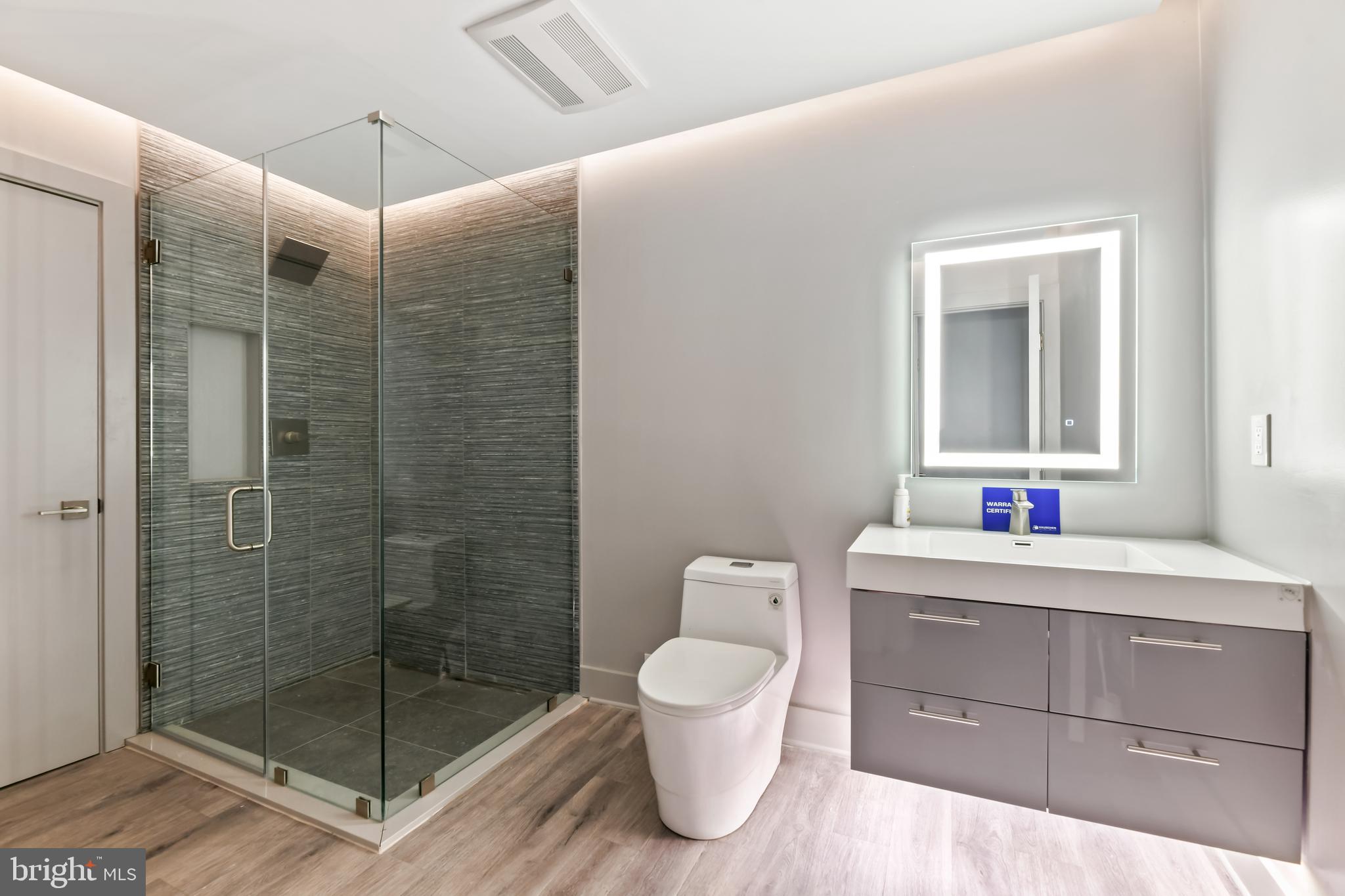 10530 Stevenson Road Stevenson, MD 21153 - Photo 72 of 98 a bathroom with a shower a sink a toilet and mirror