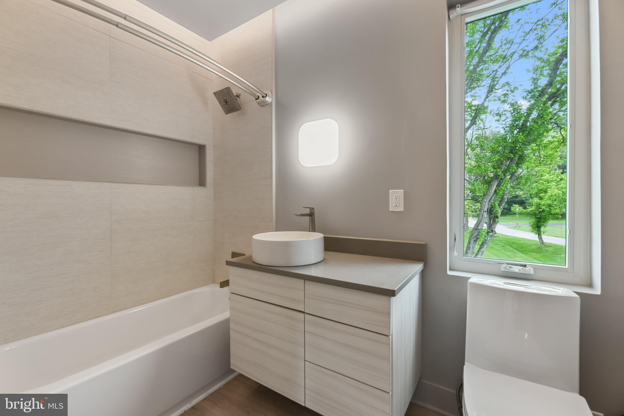 10530 Stevenson Road Stevenson, MD 21153 - Photo 73 of 98 a bathroom with a granite countertop sink a toilet and bathtub
