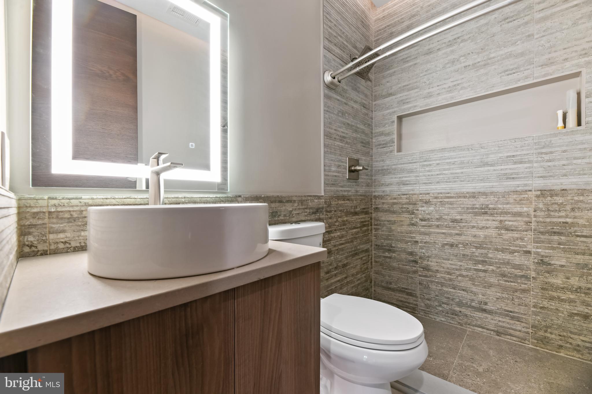 10530 Stevenson Road Stevenson, MD 21153 - Photo 74 of 98 a bathroom with a granite countertop toilet sink and mirror