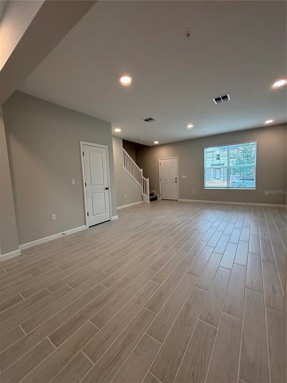 660 Pothos Street Apopka, FL 32703 - Photo 12 of 32 an empty room with wooden floor and windows
