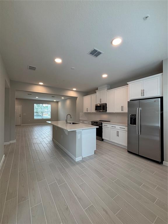 660 Pothos Street Apopka, FL 32703 - Photo 14 of 32 a large kitchen with a lot of counter space