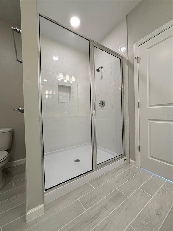 660 Pothos Street Apopka, FL 32703 - Photo 21 of 32 a bathroom with a shower and a glass door
