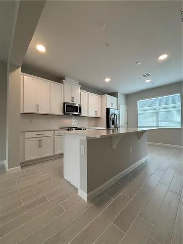 a large kitchen with cabinets