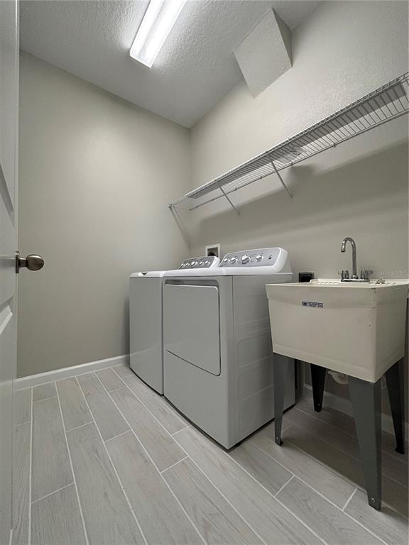 660 Pothos Street Apopka, FL 32703 - Photo 9 of 32 a utility room with dryer and washer