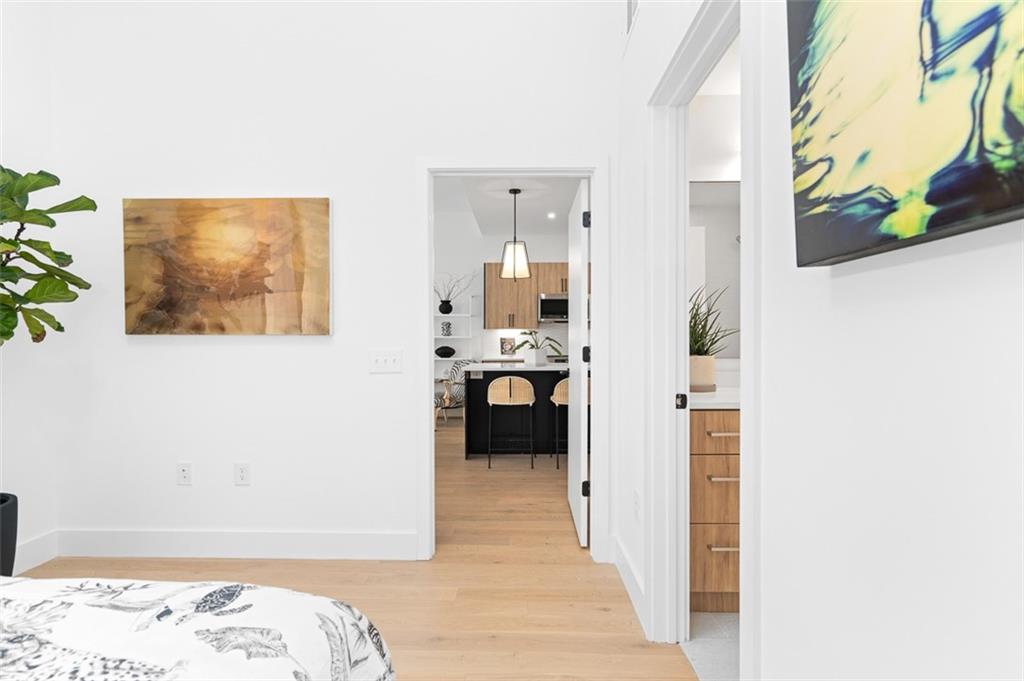 567 Ponce De Leon Avenue Northeast, Unit 516 Atlanta, GA 30308 - Photo 21 of 45 a hallway with a bed and couch