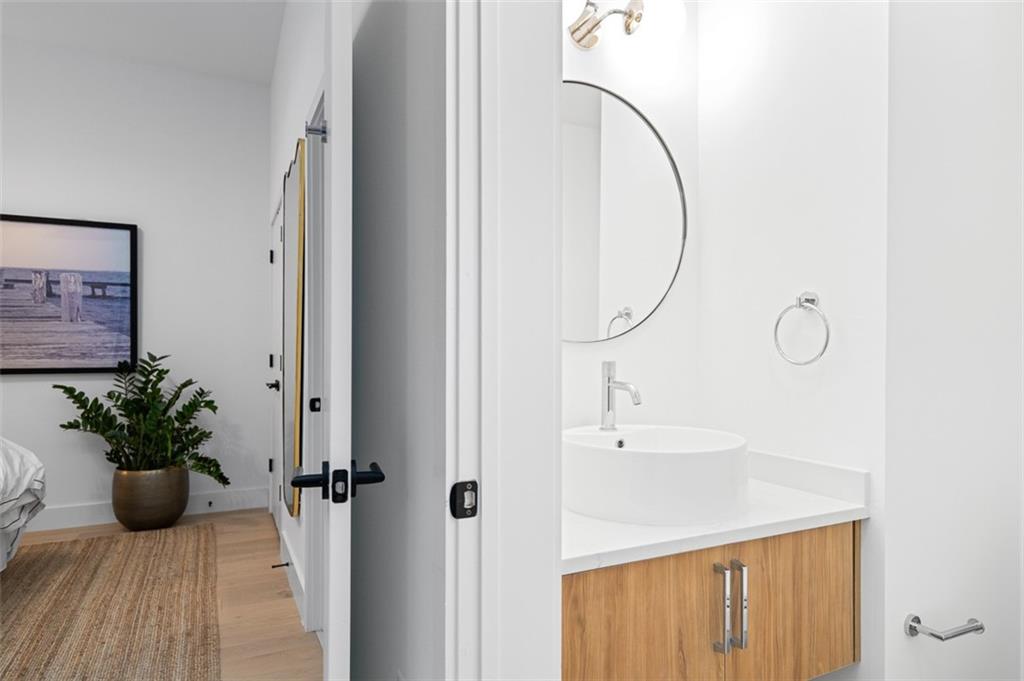 567 Ponce De Leon Avenue Northeast, Unit 516 Atlanta, GA 30308 - Photo 31 of 45 a bathroom with a sink and a mirror