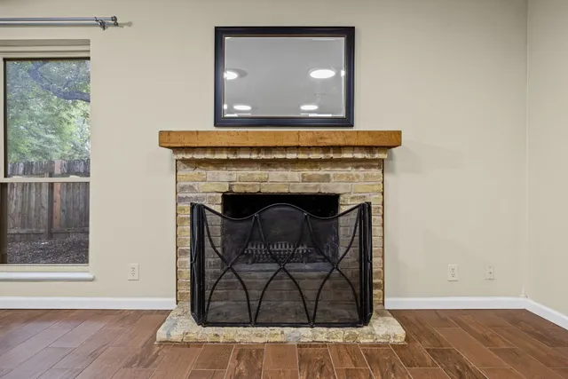 a living room with a fireplace and a wooden floor