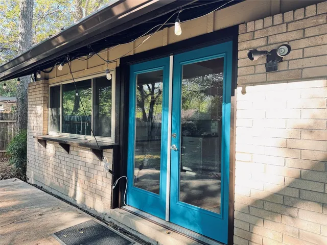 a view of a brick house with a large window