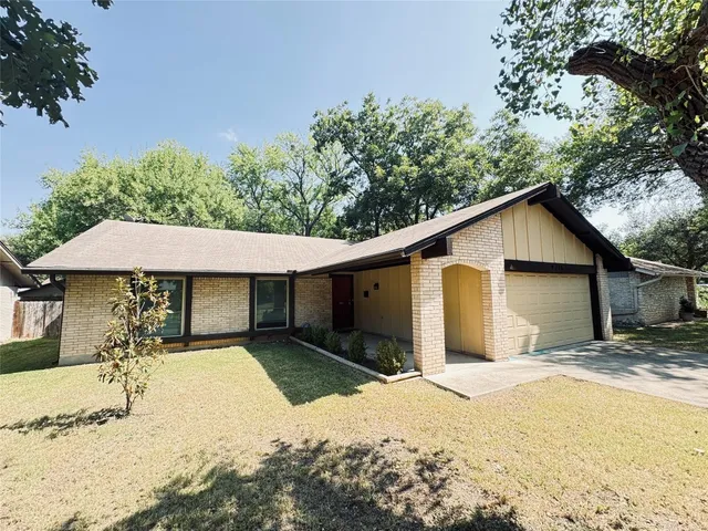 a view of a house with a yard covered in snow