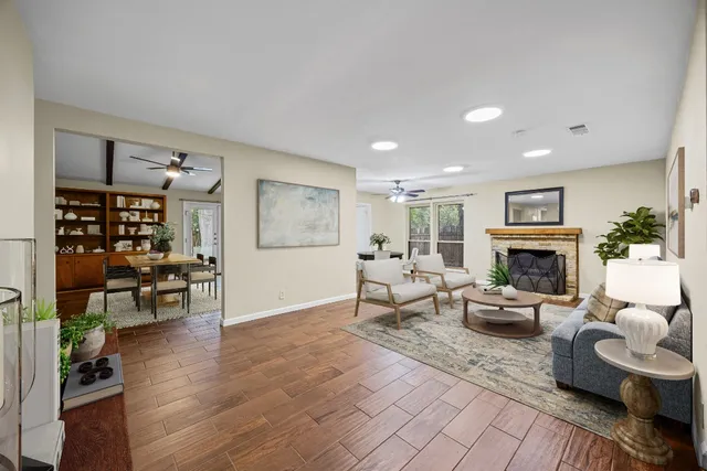 a living room with furniture wooden floor and a fireplace