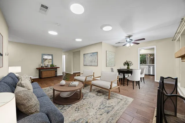 a living room with furniture and view of kitchen
