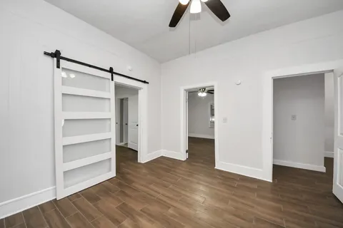 a view of an empty room and wooden floor
