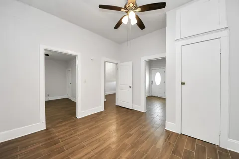 a view of an empty room and wooden floor