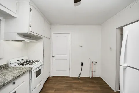 a kitchen with stainless steel appliances granite countertop a sink and a refrigerator