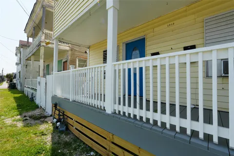 a view of a blue building with a small yard