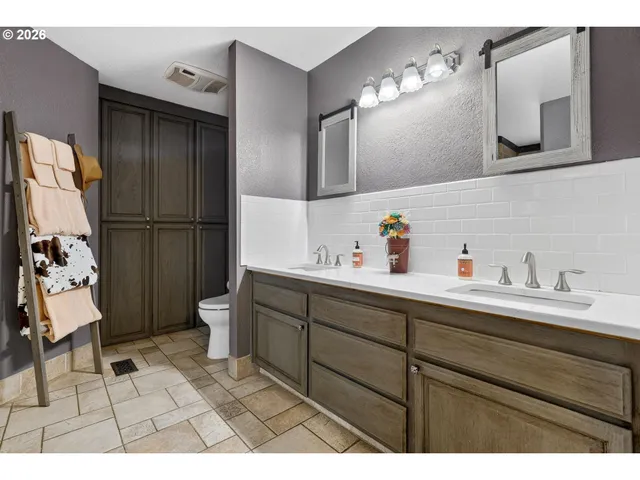 a hallway with a sink and cabinets