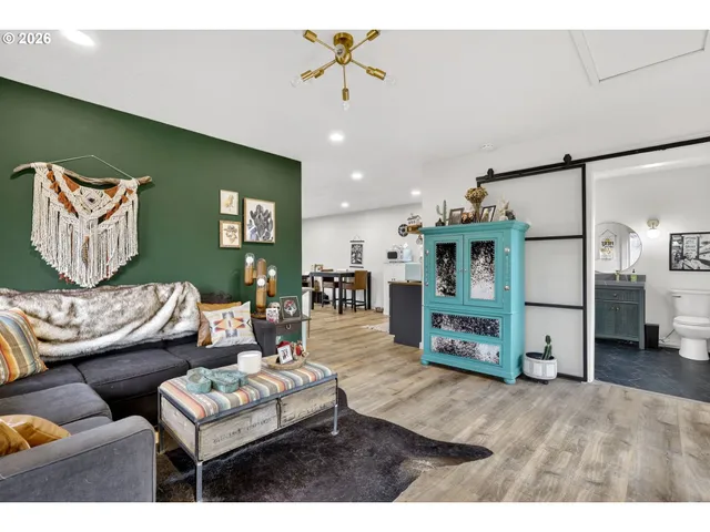 a living room with granite countertop furniture and kitchen view