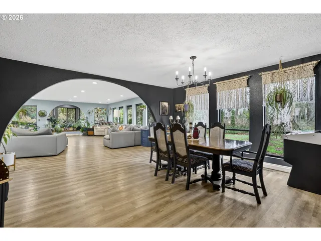 a dining room with furniture window and wooden floor