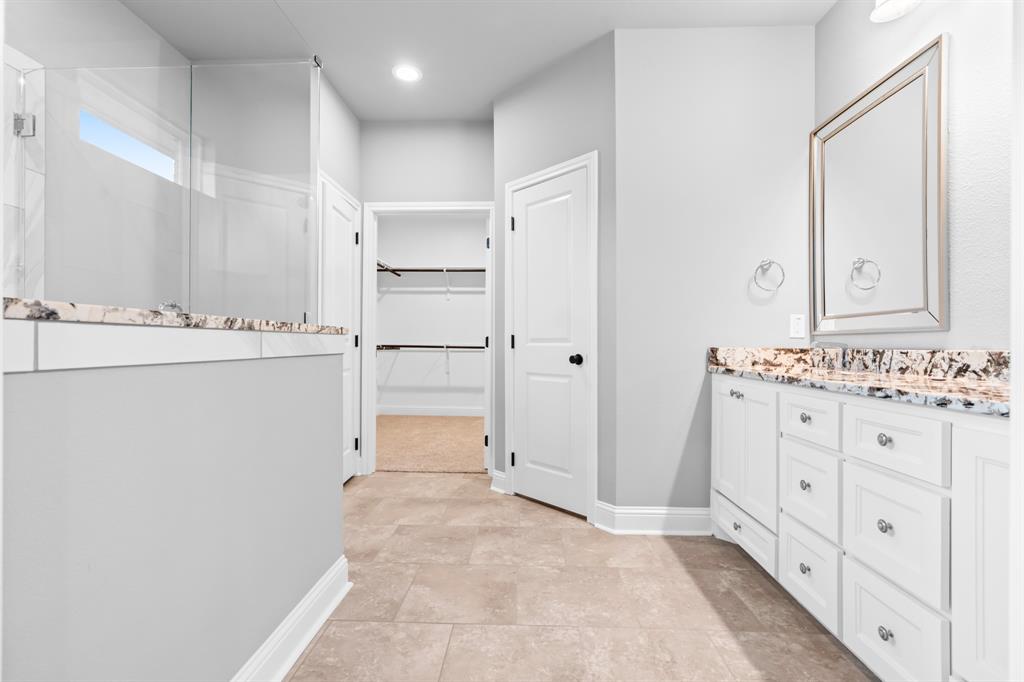120 Water View Lane Robinson, TX 76706 - Photo 17 of 34 Master bathroom featuring walk in shower, vanity, and spacious walk-in closet
