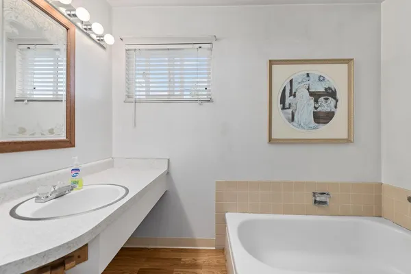 a bathroom with a bathtub and a sink