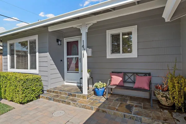 a front view of a house with outdoor seating