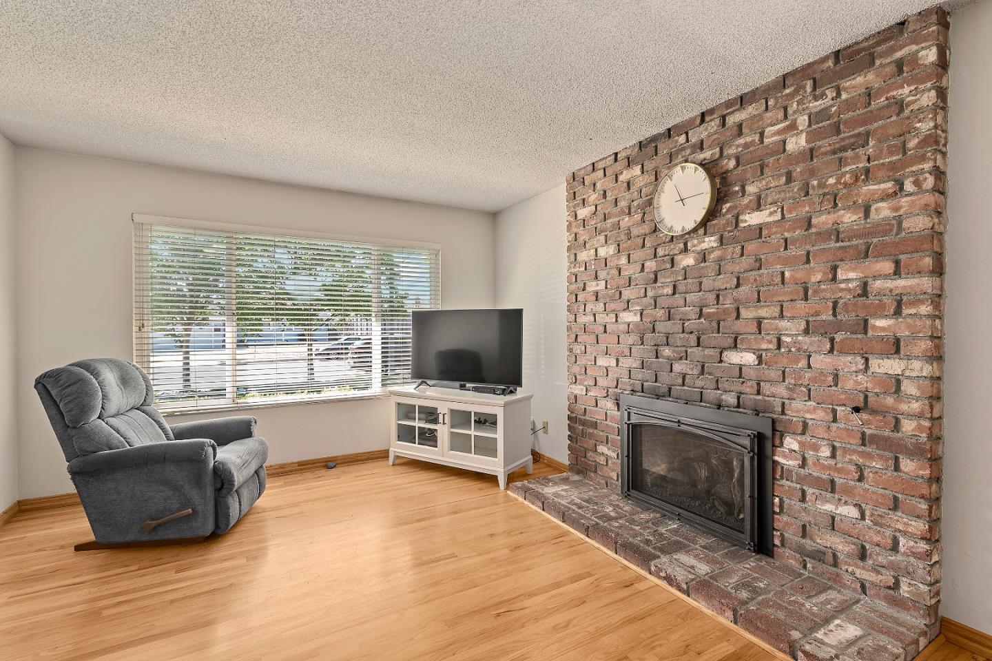 1471 Inskip Drive Campbell, CA 95008 - Photo 4 of 21 a living room with a fireplace furniture a flat screen tv and a floor to ceiling window