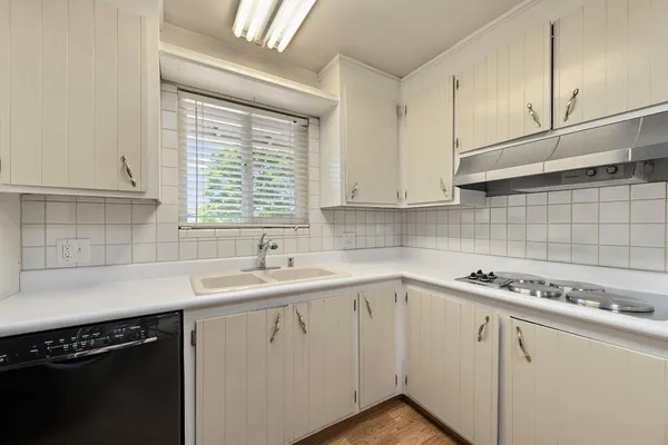 a kitchen with a sink cabinets and window