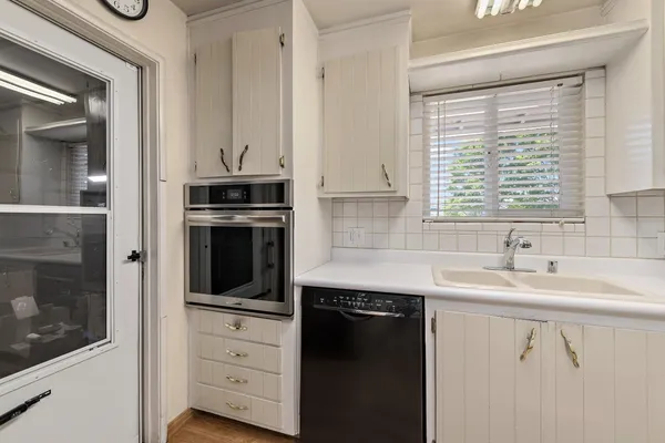 a kitchen with a sink stove and microwave