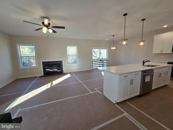 a bathroom with a tub sink double vanity granite and a mirror