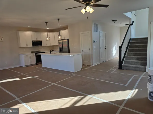 a view of a big house with a big yard and large trees