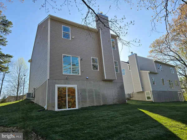 a kitchen that has a lot of cabinets in it and wooden floor