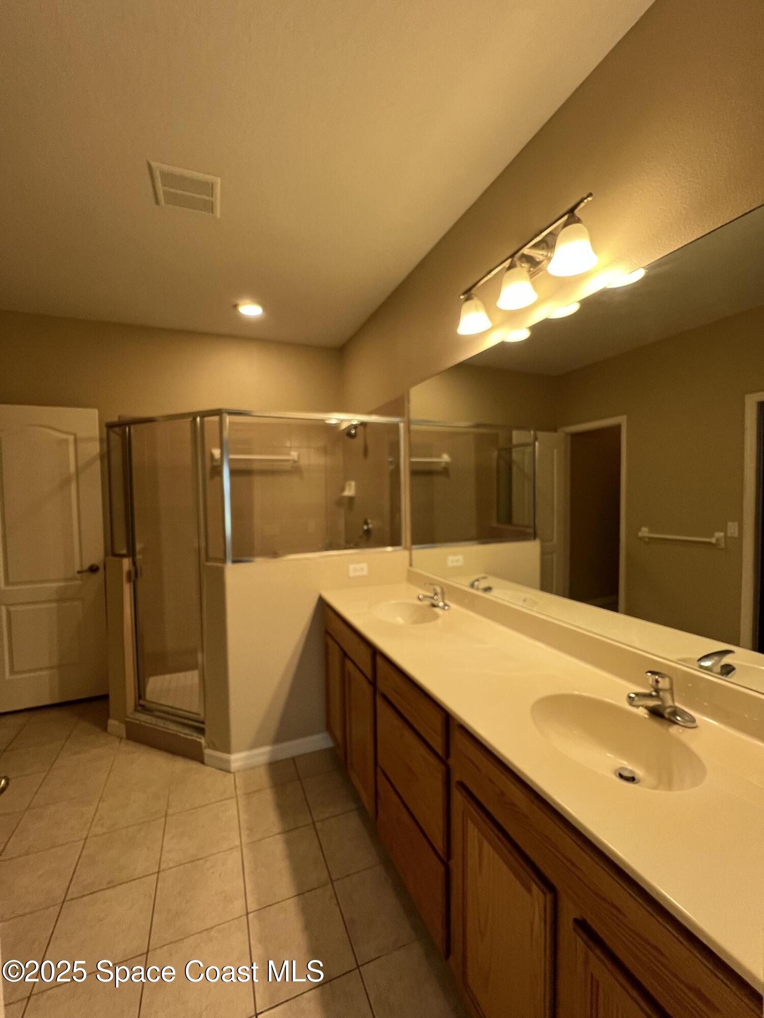 1040 Venetian Drive, Unit 203 Melbourne, FL 32904 - Photo 13 of 23 a bathroom with a sink and mirror