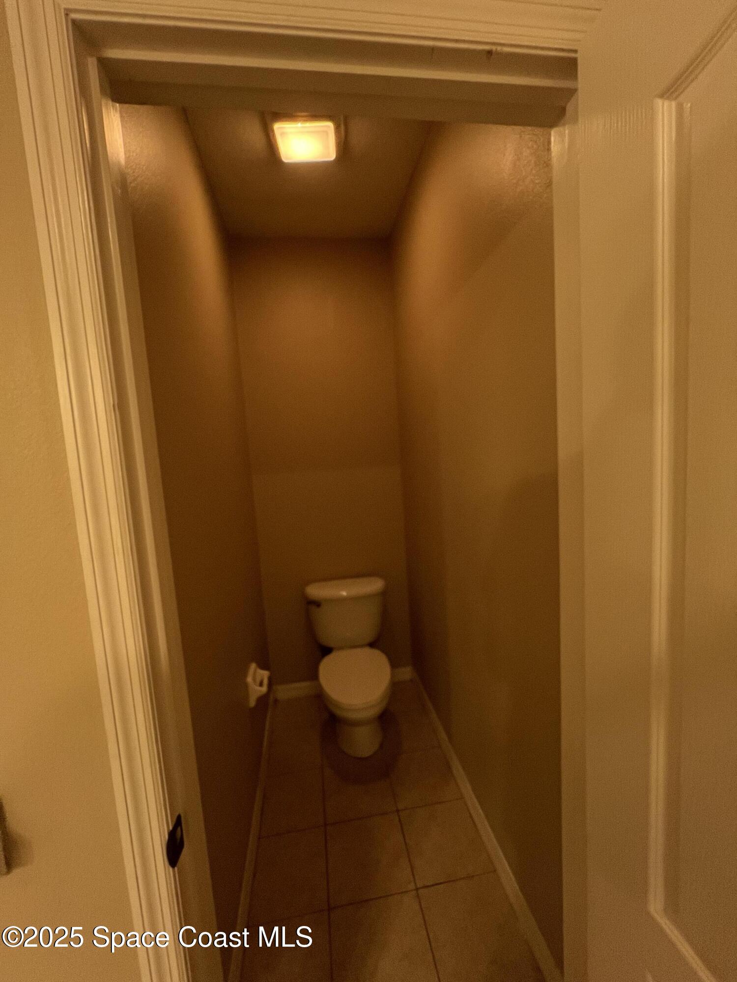 1040 Venetian Drive, Unit 203 Melbourne, FL 32904 - Photo 15 of 23 a bathroom with a toilet and a shower