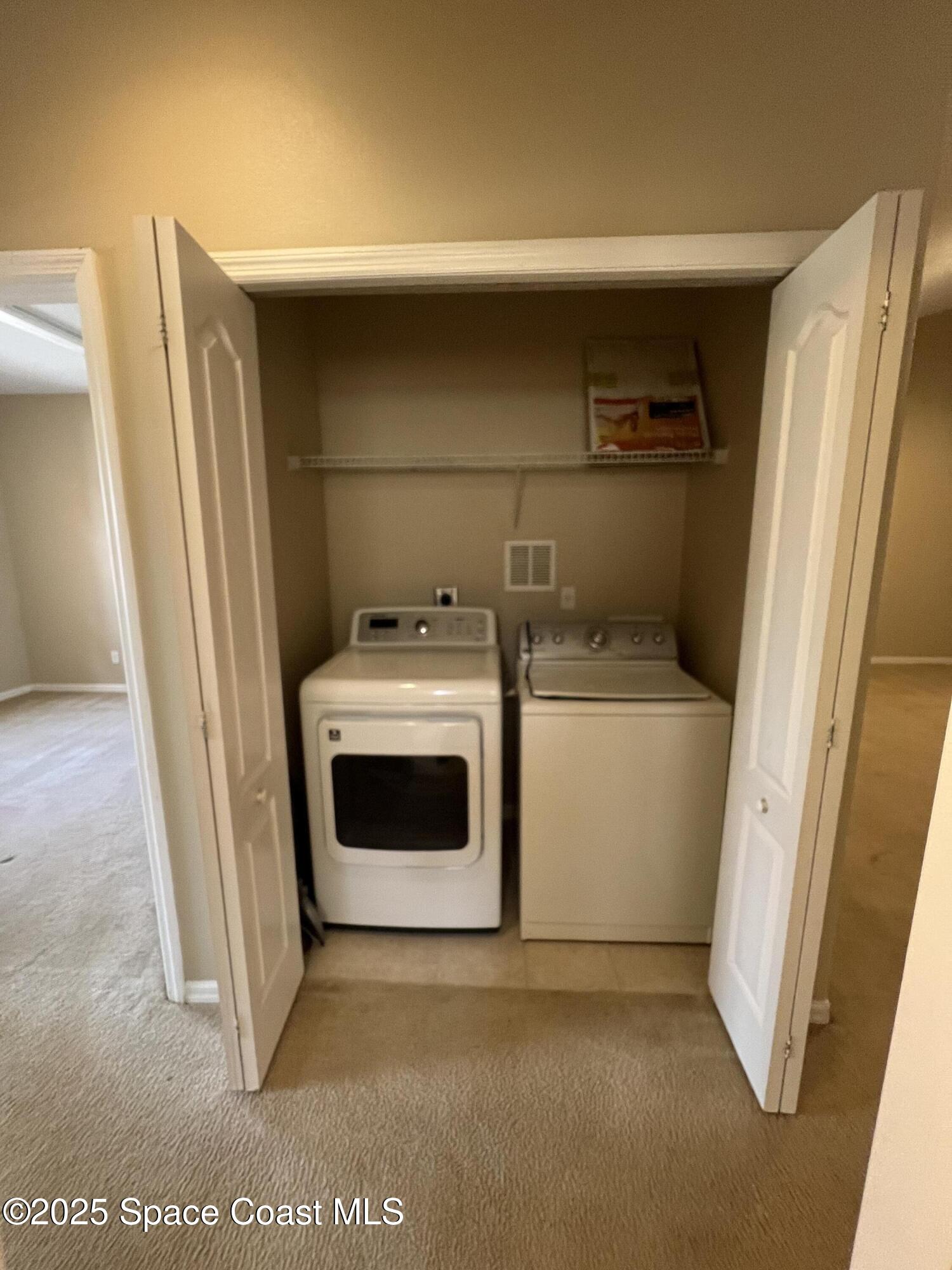 1040 Venetian Drive, Unit 203 Melbourne, FL 32904 - Photo 17 of 23 a utility room with dryer and washer