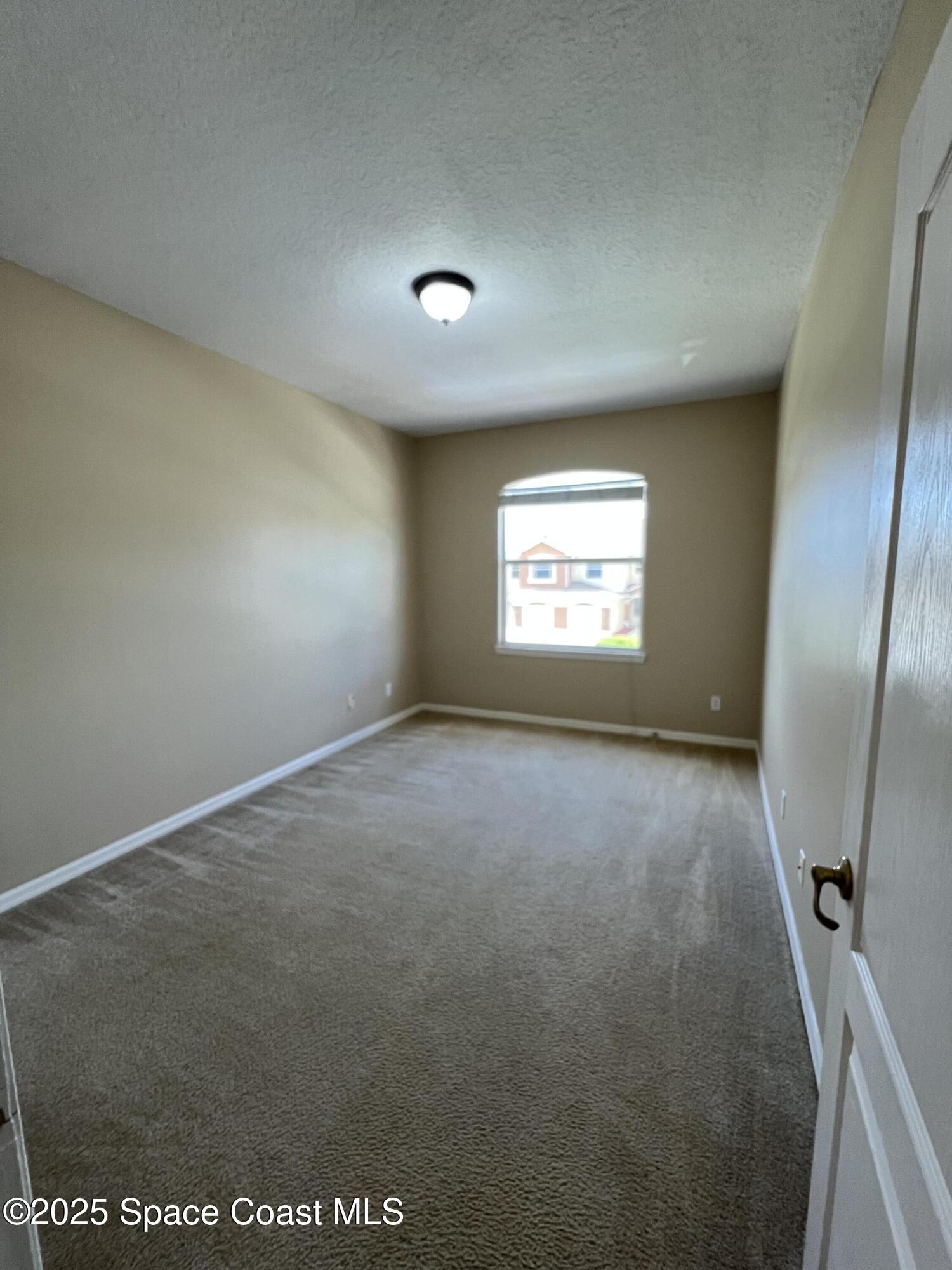 1040 Venetian Drive, Unit 203 Melbourne, FL 32904 - Photo 19 of 23 an empty room with windows