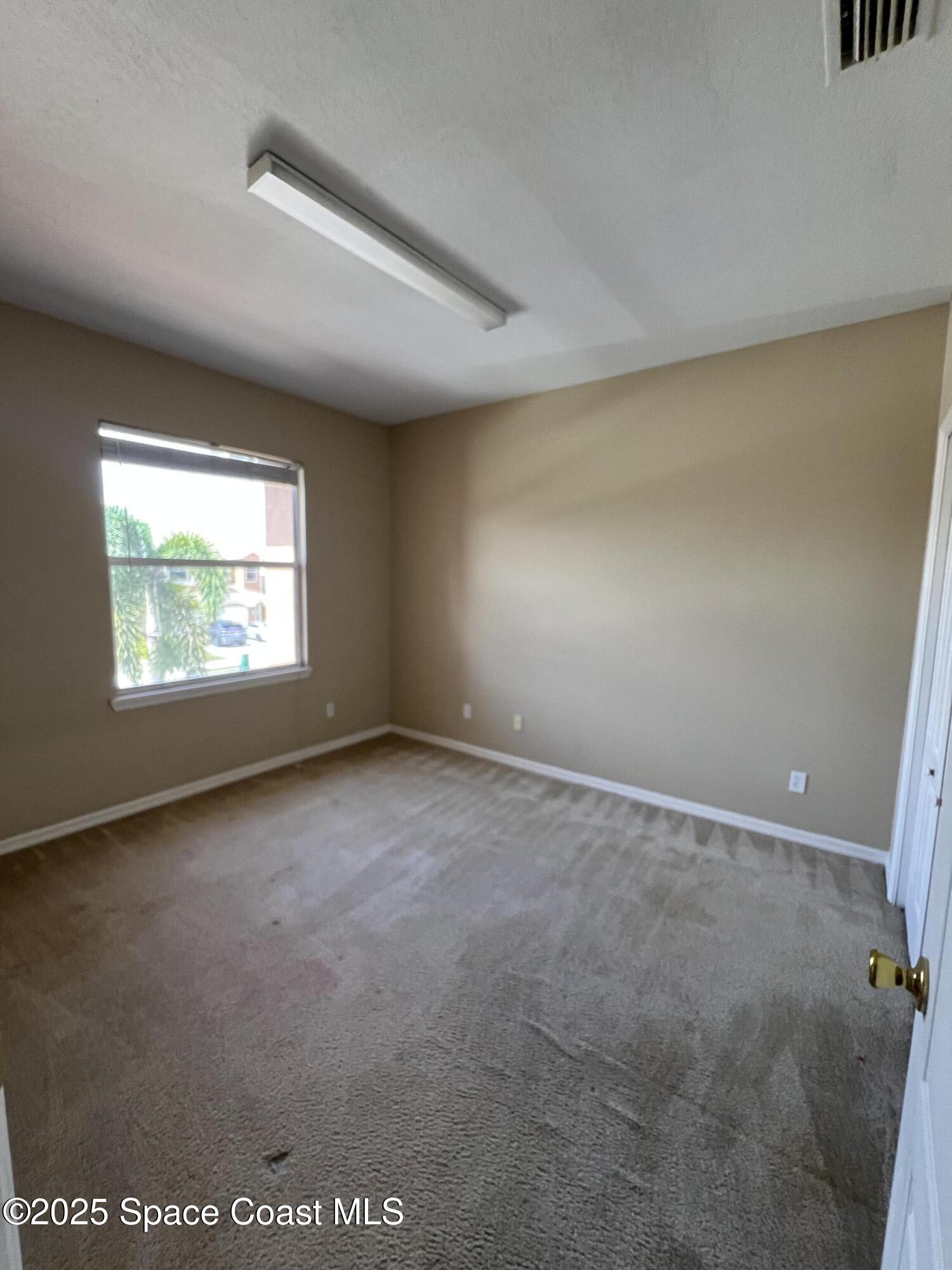 1040 Venetian Drive, Unit 203 Melbourne, FL 32904 - Photo 21 of 23 an empty room with windows