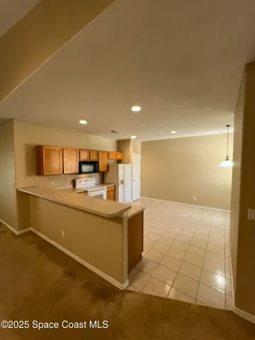 a kitchen with stainless steel appliances a refrigerator and a stove top oven