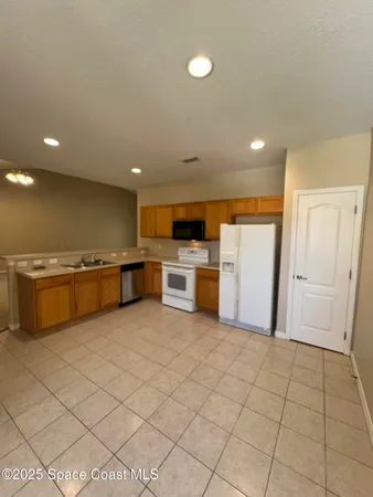 a view of kitchen with granite countertop cabinets