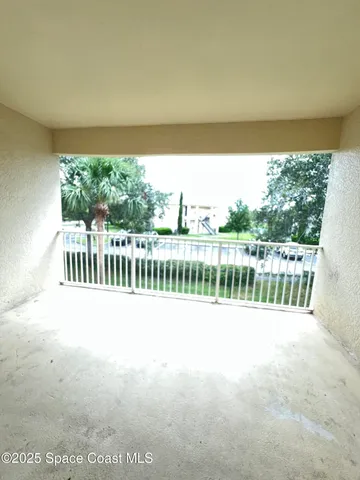 an empty room with a empty space and windows