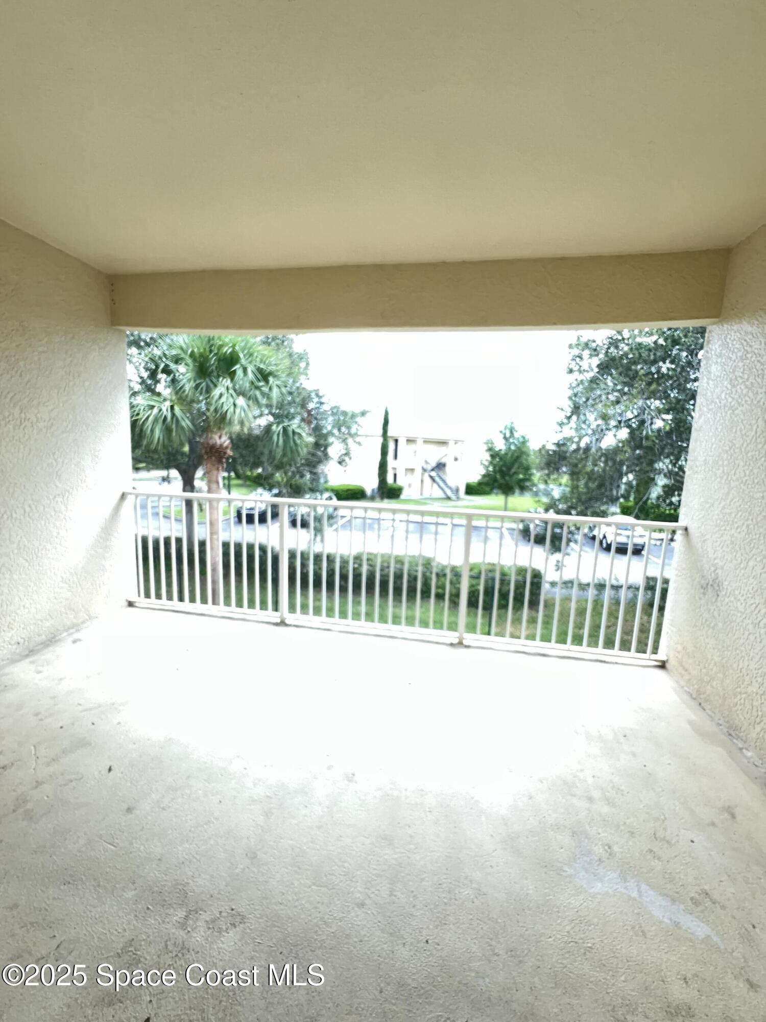 1040 Venetian Drive, Unit 203 Melbourne, FL 32904 - Photo 10 of 23 a view of balcony with furniture and garden