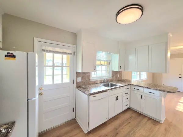 a room with a chair and a refrigerator