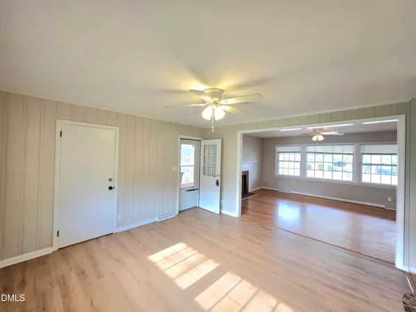 wooden floor in an empty room with a window