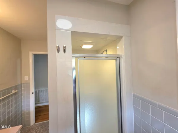 a view of a house with a yard and large tree