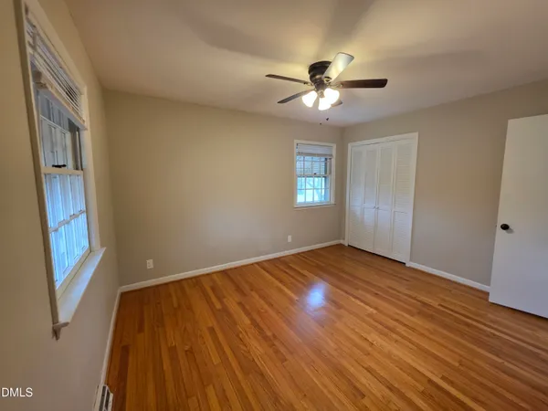 a view of a patio with a table and chairs under an umbrella