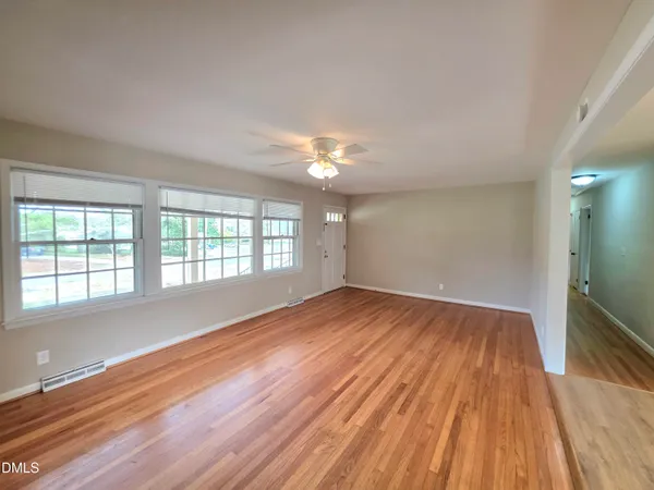 a view of livingroom with natural light and hardwood