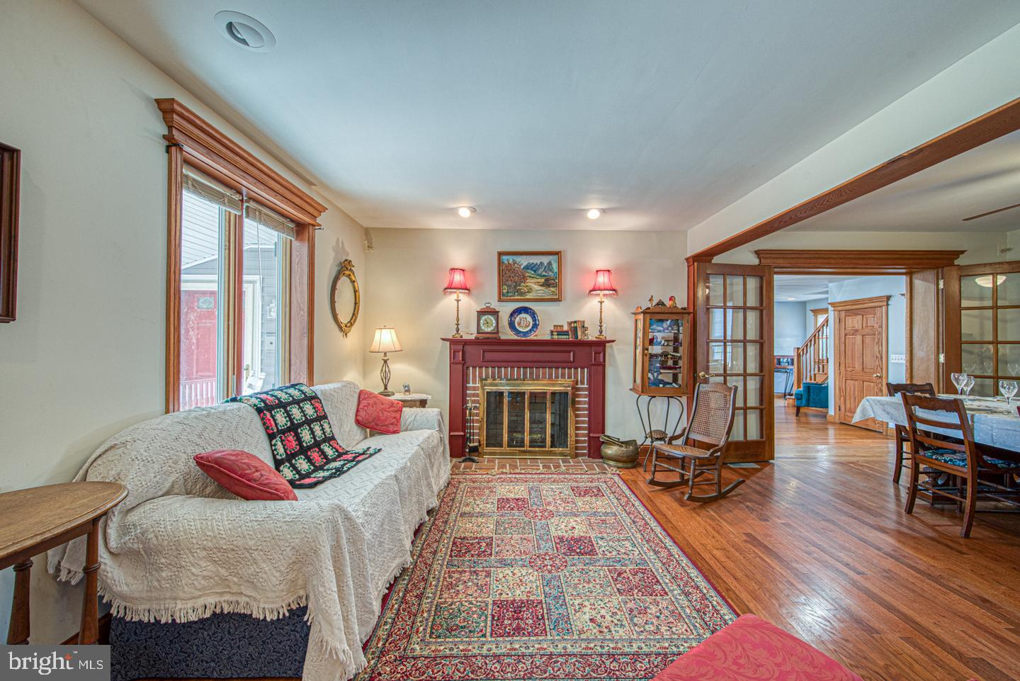 470 Farnum Road Media, PA 19063 - Photo 4 of 66 a living room with furniture a fireplace and large windows