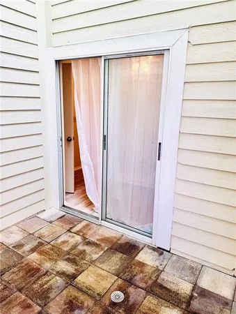 a view of a door with wooden floor and a window