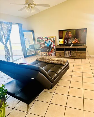 a kitchen with a sink a stove and black cabinets