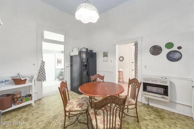 a dining room with furniture and window